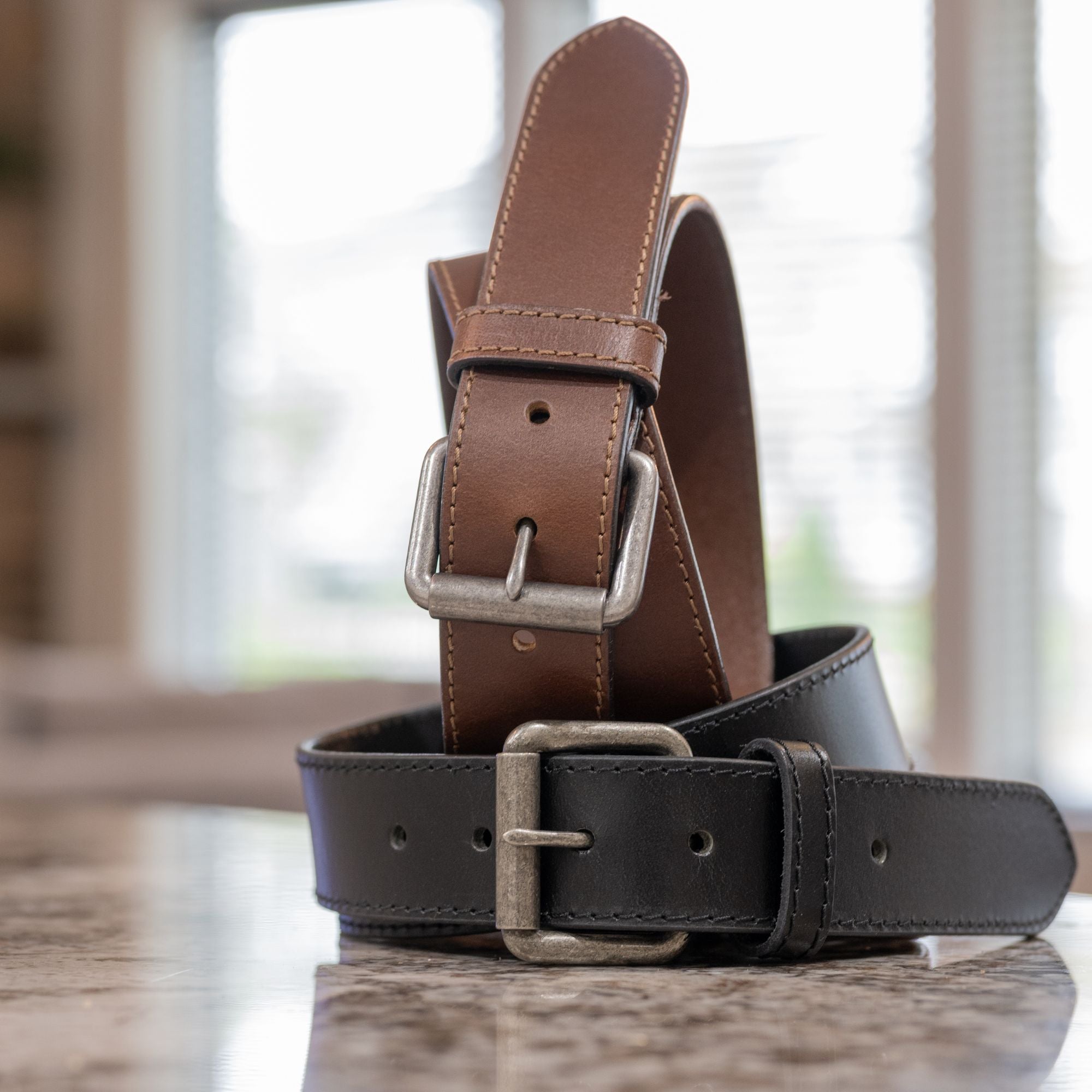 Outback Leather Belt Set by Nickel Zero | Two belts, one with a black strap and one brown.