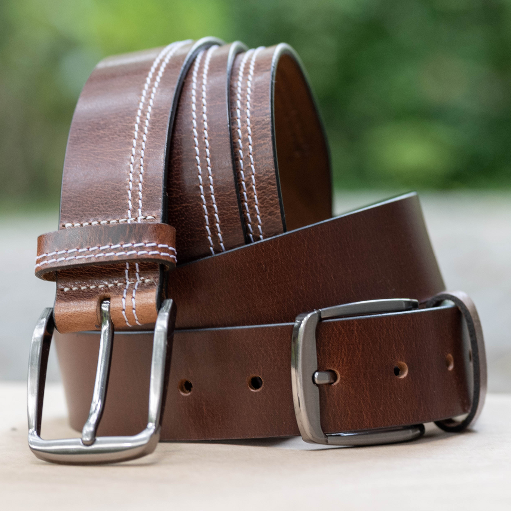 Millennial Brown Leather Belt Set. Outdoor setting. 1 solid brown, 1 with double white stitch.