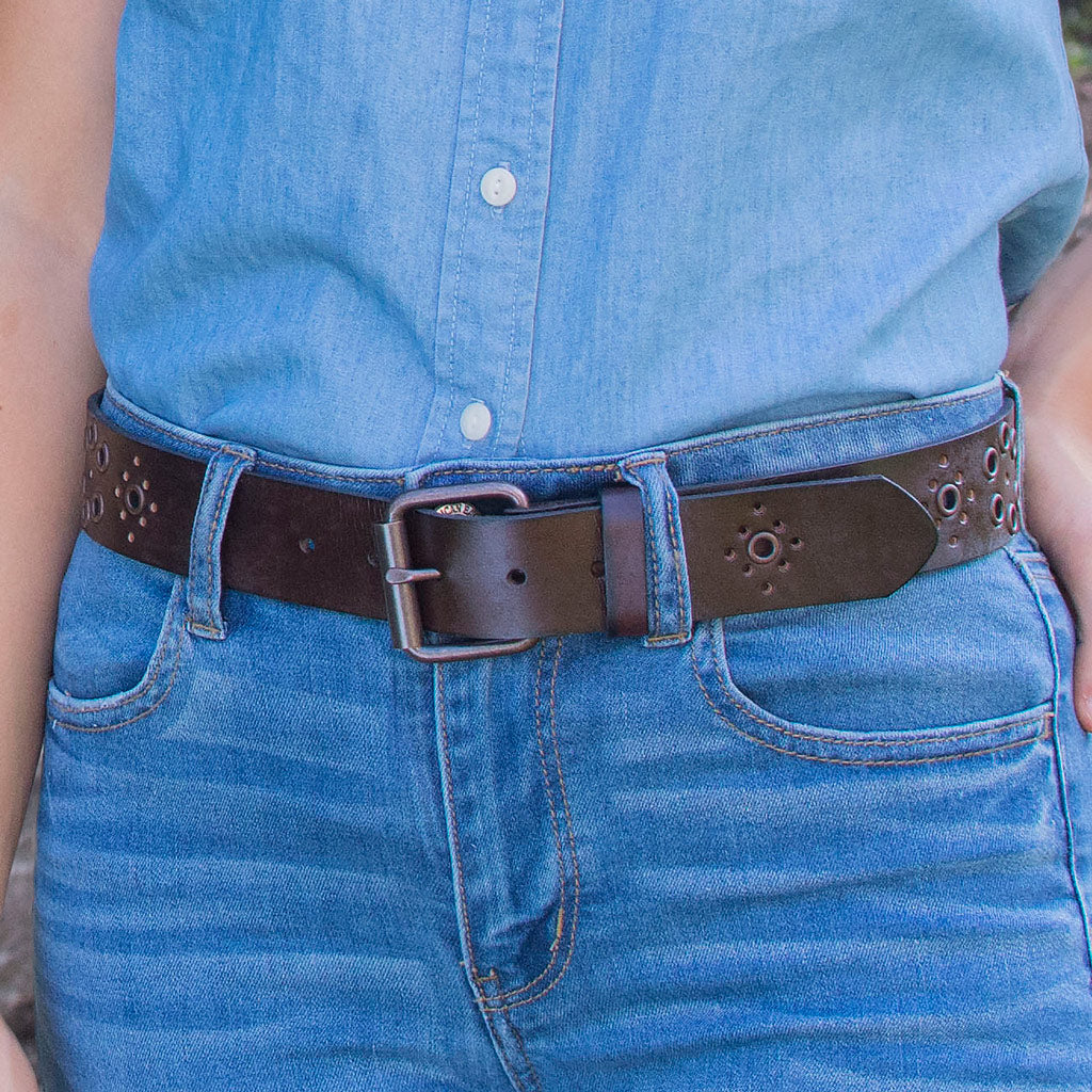 Women's Grommet Brown Leather Belt on model in jeans. Fun casual belt. Thin rectangular buckle.