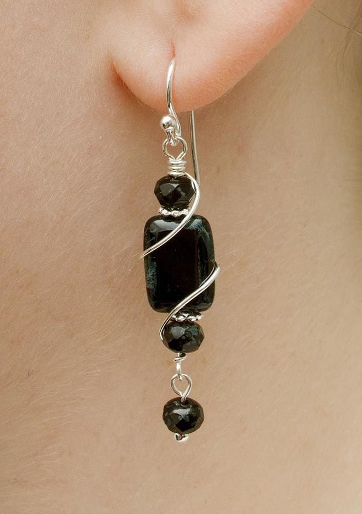 Cape Hatteras Earring on model. Glass oval sandwiched between 2 beads and one dangling bead.
