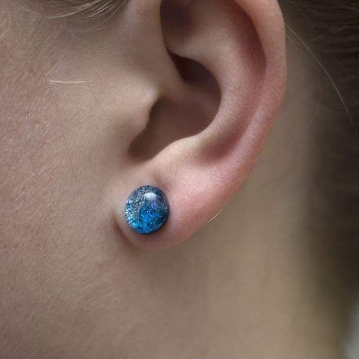 Cosmic Earrings on model. Hypoallergenic nickel-free earrings; small studs in shades of blue.