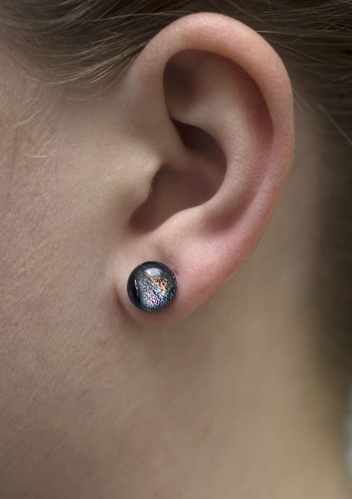 Galaxy Quest Earrings on model. No rash! Circular earrings are 4-6mm, smaller than earlobe.