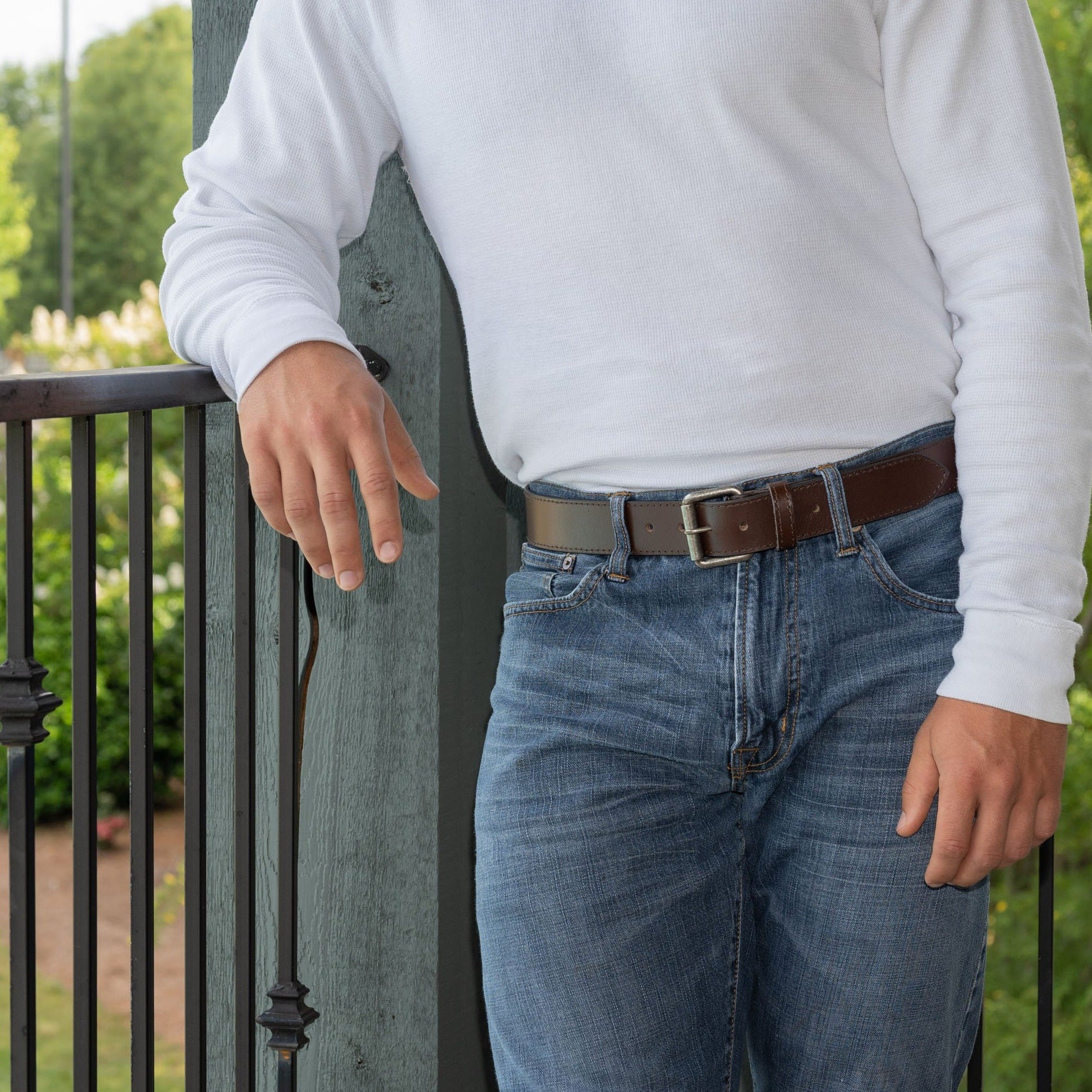 Outback Brown Leather Belt on model. Great for wear with jeans. Dark brown strap; silvery buckle.