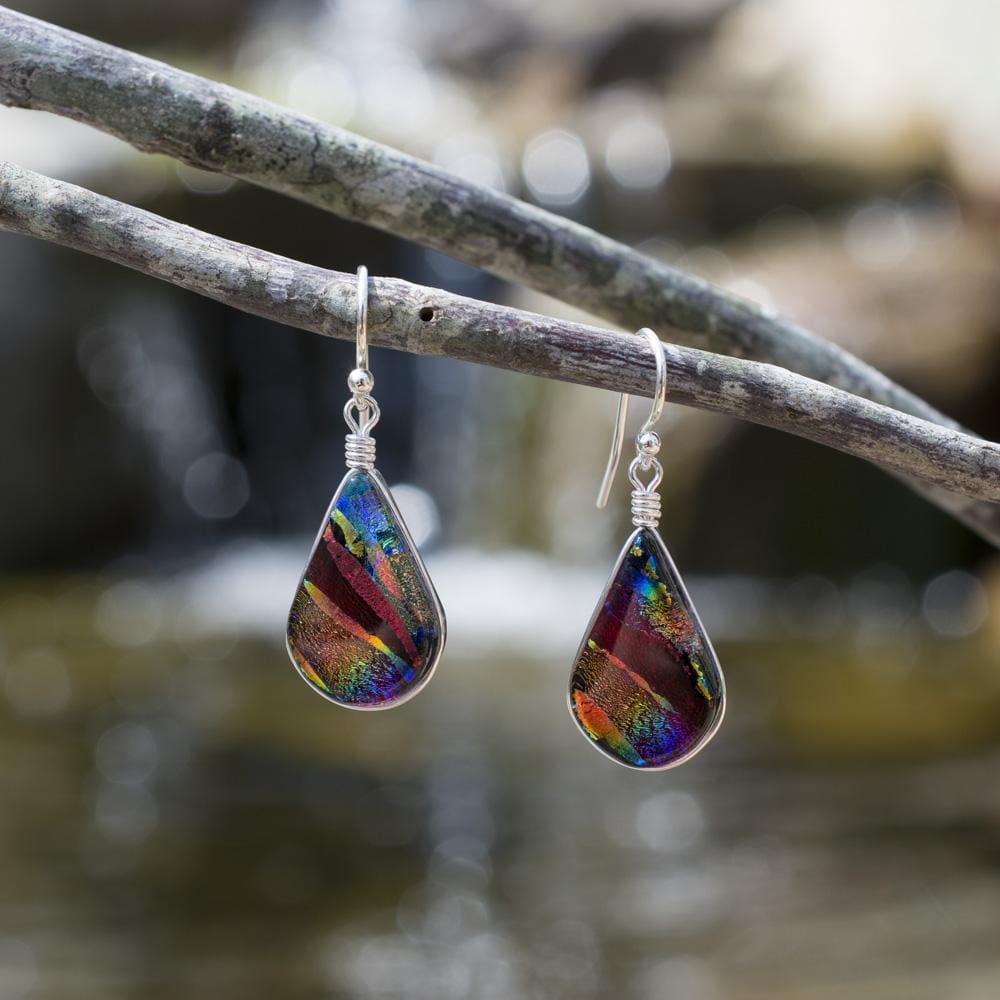 Rainbow Falls Earrings - Rainbow Red. Outdoor setting. Depths of rainbow colored dichroic glass.