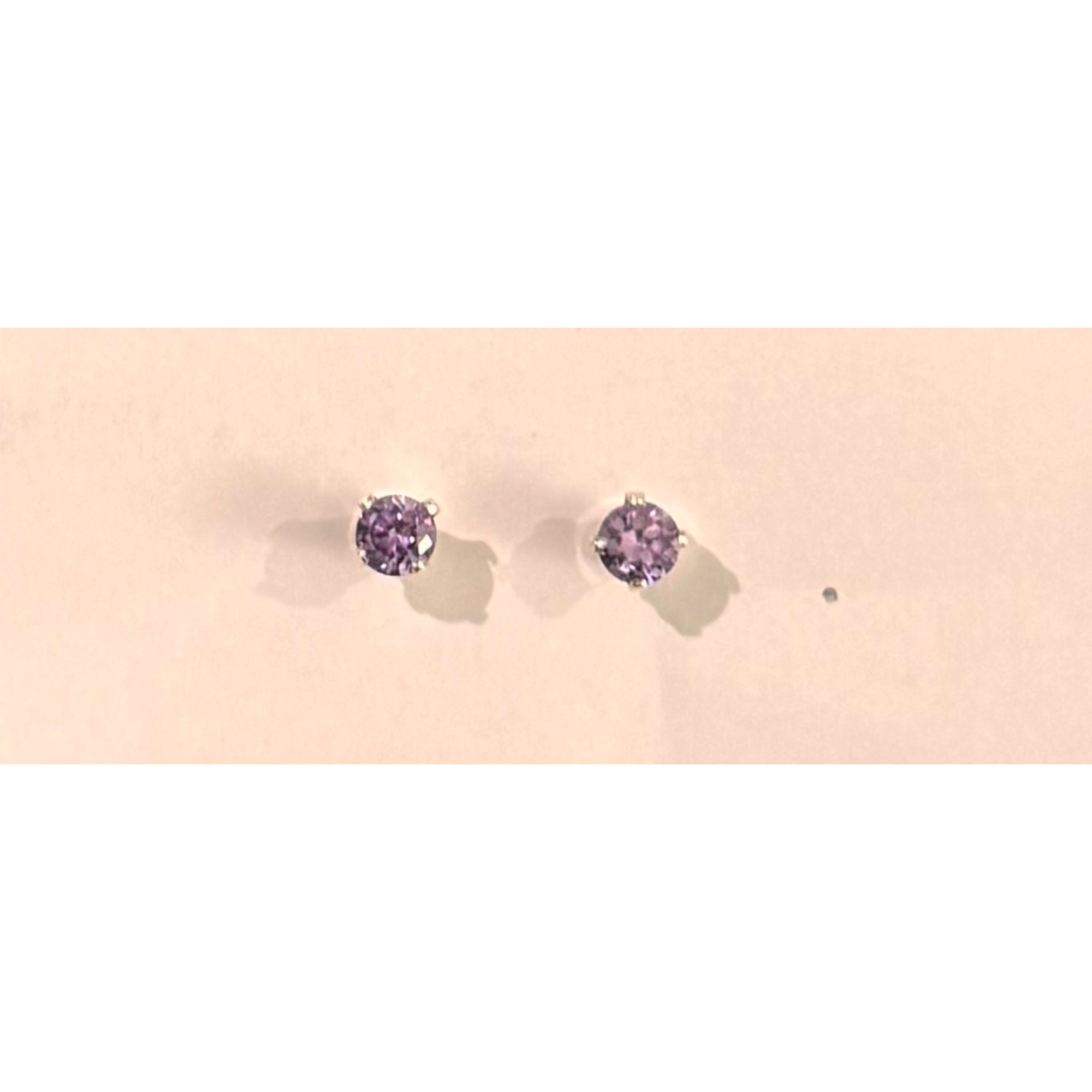 4 mm round cut lavender stone in 4 prong sterling silver setting. Nickel free