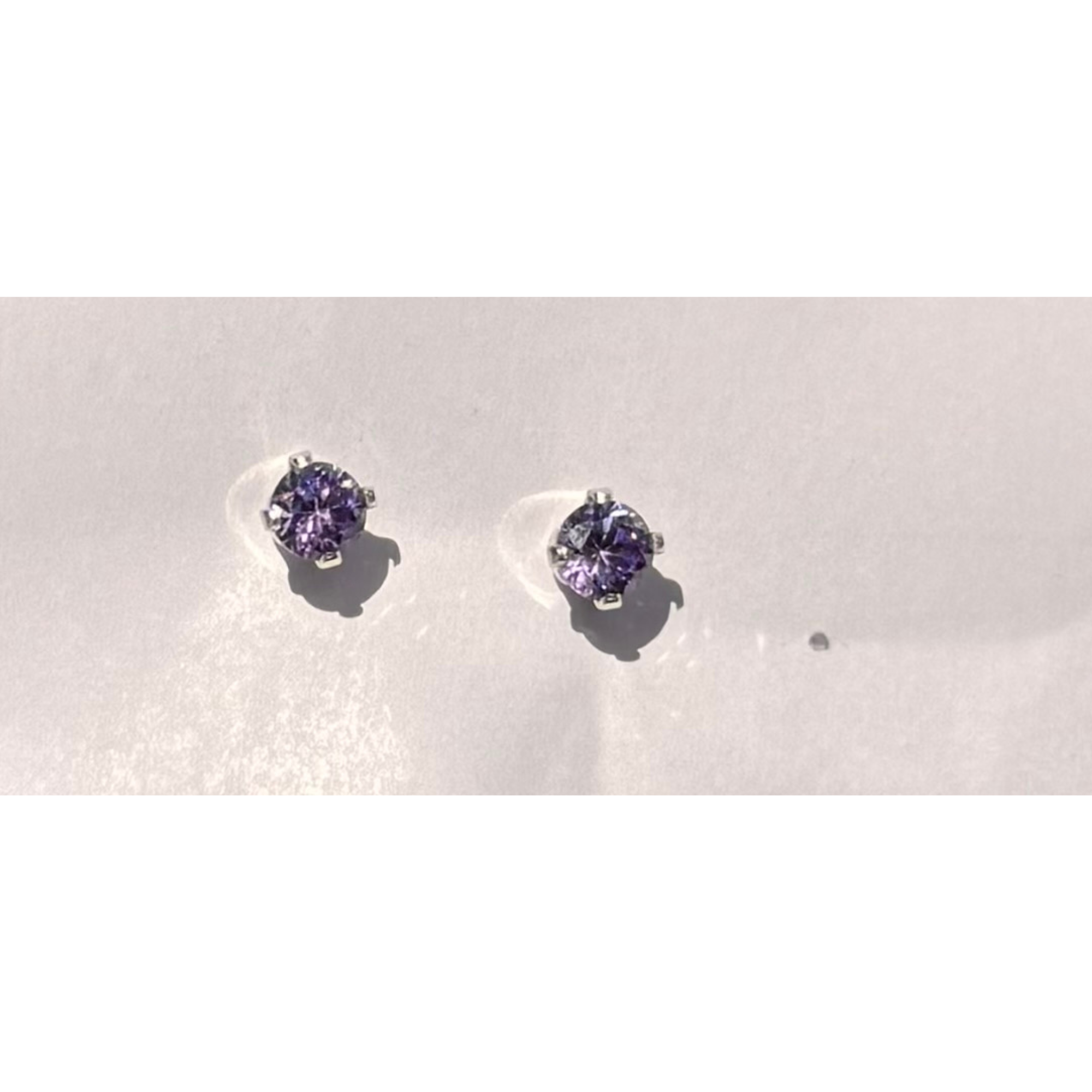 4 mm round cut lavender stone with sterling silver setting. Nickel free