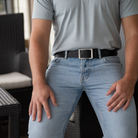 Site Manager Black Leather Belt on model wearing blue jeans and t-shirt. Stainless Steel buckle