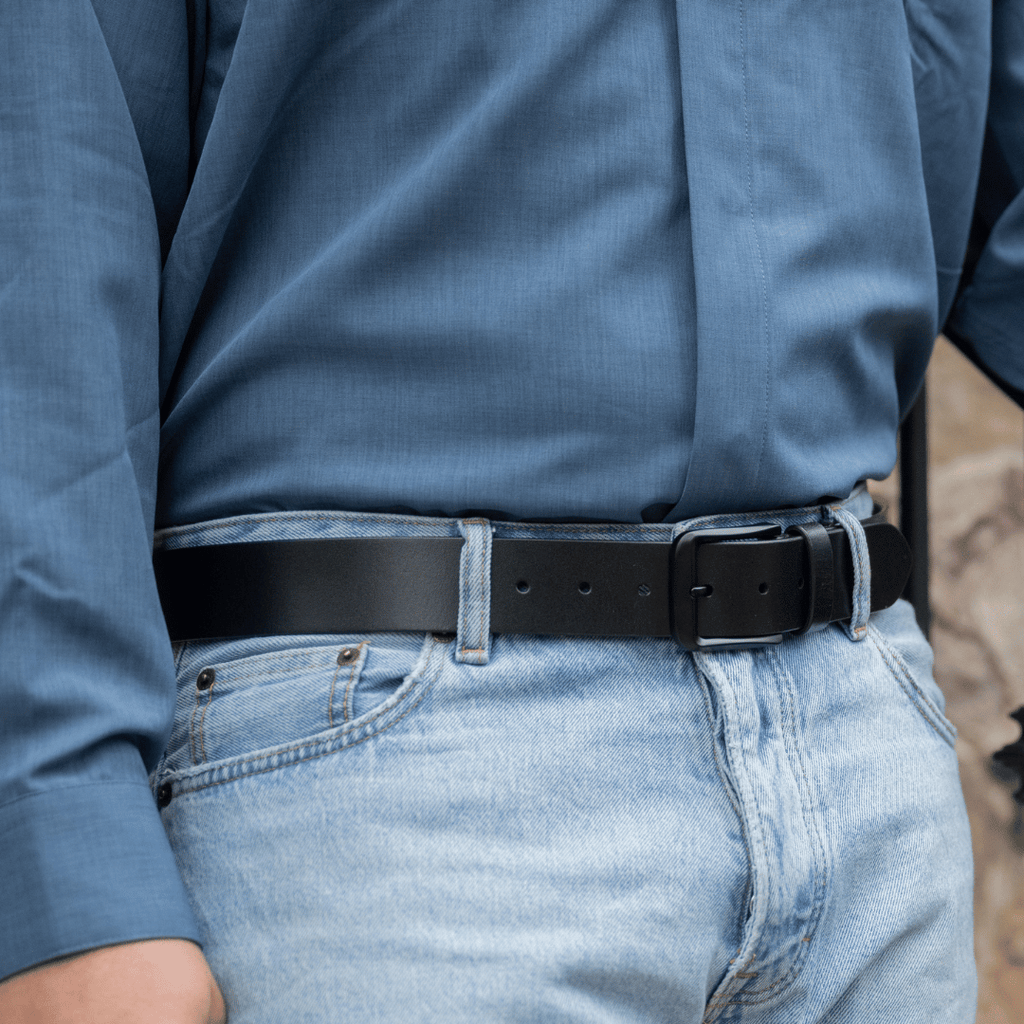 Image of Black Mountain Leather Belt on model wearing blue jeans and blue shirt. Black Buckle