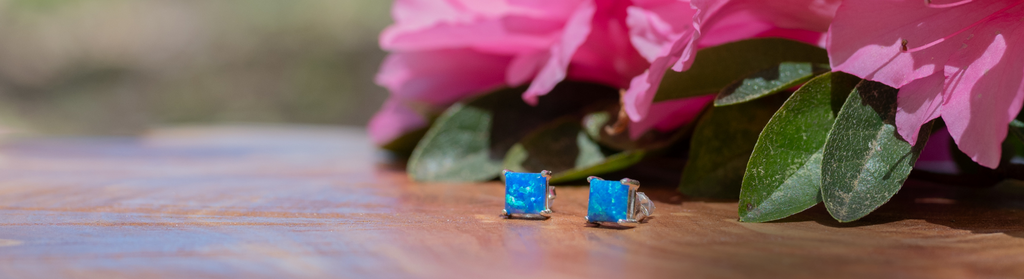 Mother's Day Slider with image of a pair of blue fiery opals and pink azaleas. Promo code: Mom24