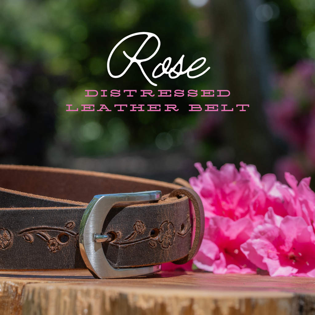 1.25 inch strap. distressed brown leather with silver arched buckle. Nickel free. outdoor picture.