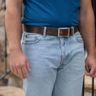 Site Manager Distressed Brown Leather Belt on model wearing blue jeans and blue t-shirt.