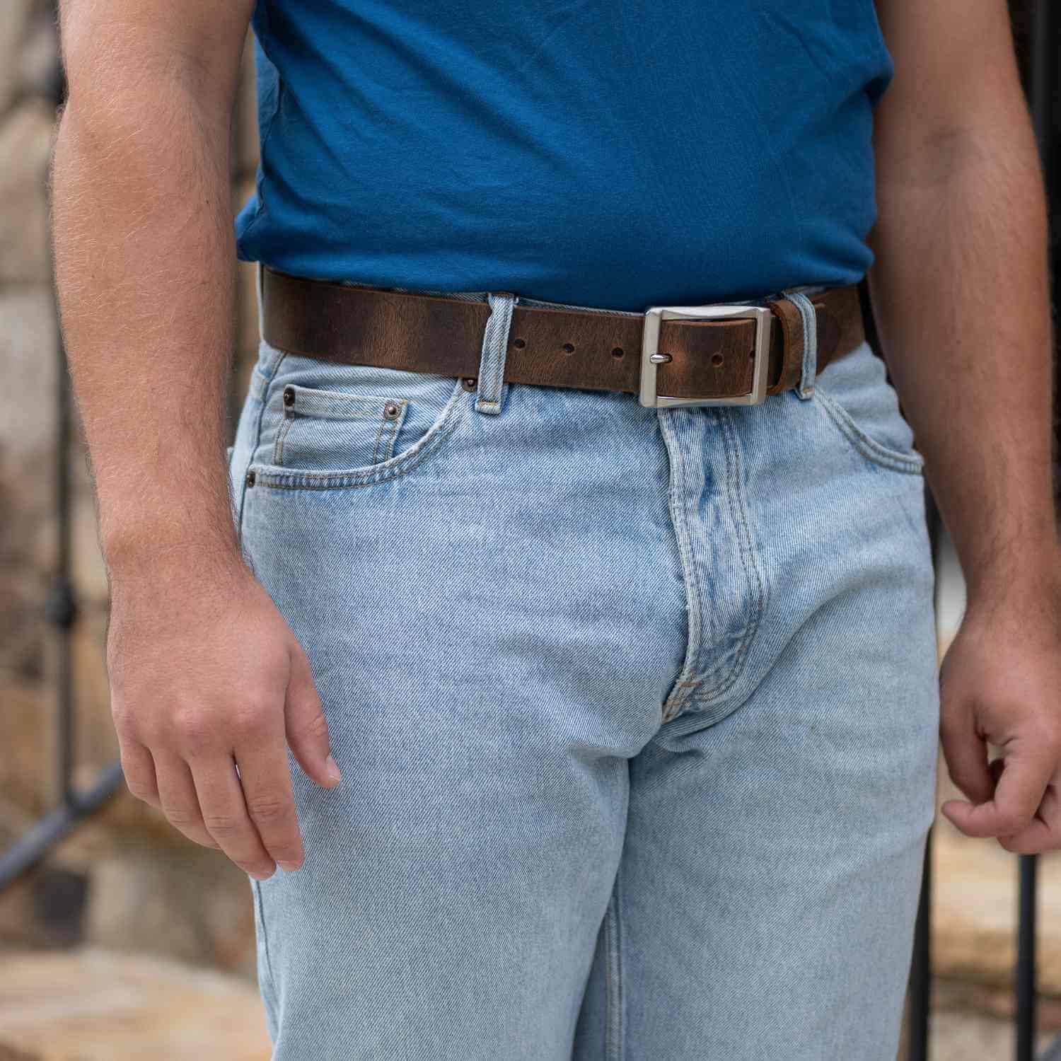 Site Manager Distressed Brown Leather Belt on model wearing blue jeans and blue t-shirt.