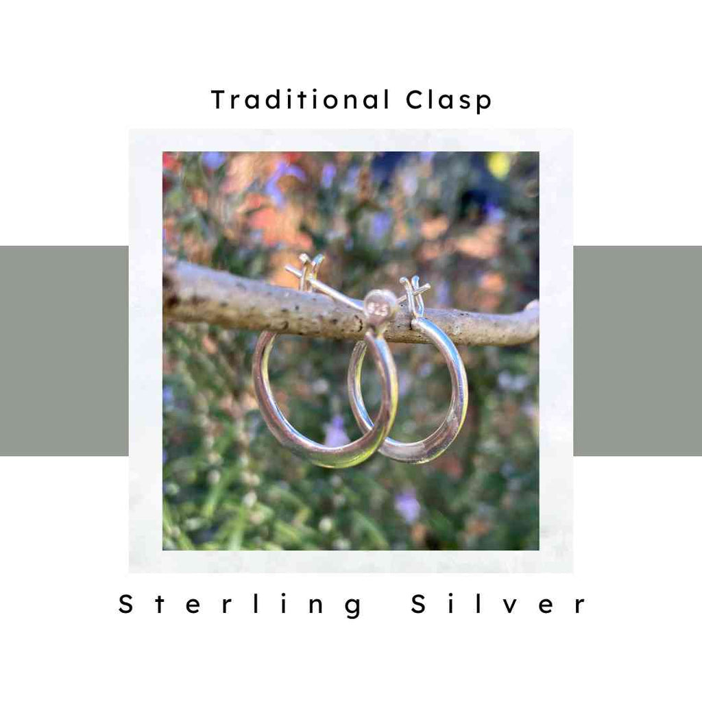 925 sterling silver hoop earrings hanging on a tree branch. 20 mm traditional back closure.