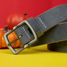 Cold Mountain Gray Belt coiled and with a yellow and orange background.