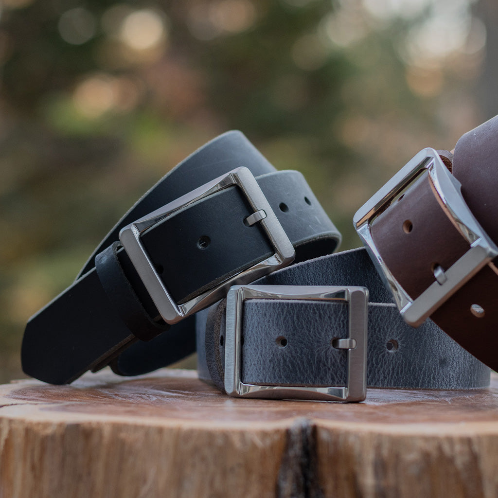 Image of a black leather belt, brown leather belt and gray leather belt.  All full grain leather with titanium work buckles.