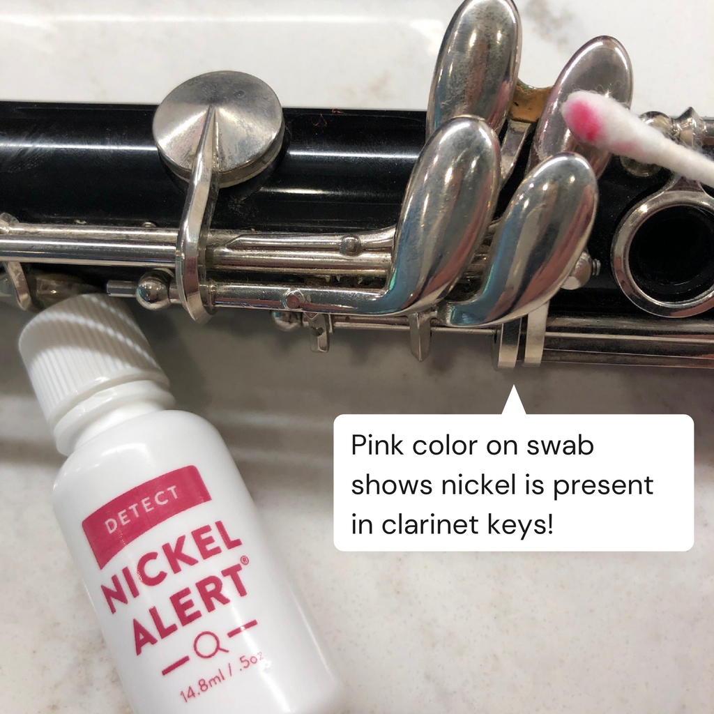 Nickel Alert testing the keys on a clarinet. Pink color on swab shows nickel is present in keys.