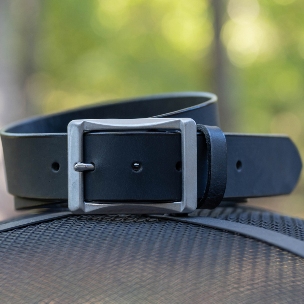 Image of 1.5 inch black leather strap with stainless steel center bar buckle. USA