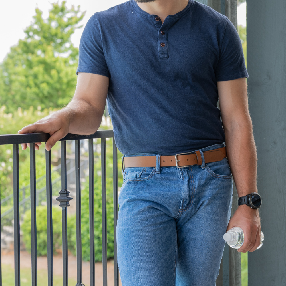 Slick City Brown Leather Belt on model in jeans. Leather strap is light brown to tan colored.