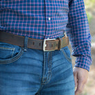 Titanium Wide Pin Distressed Leather Belt on model in jeans. Distressed brown leather strap.