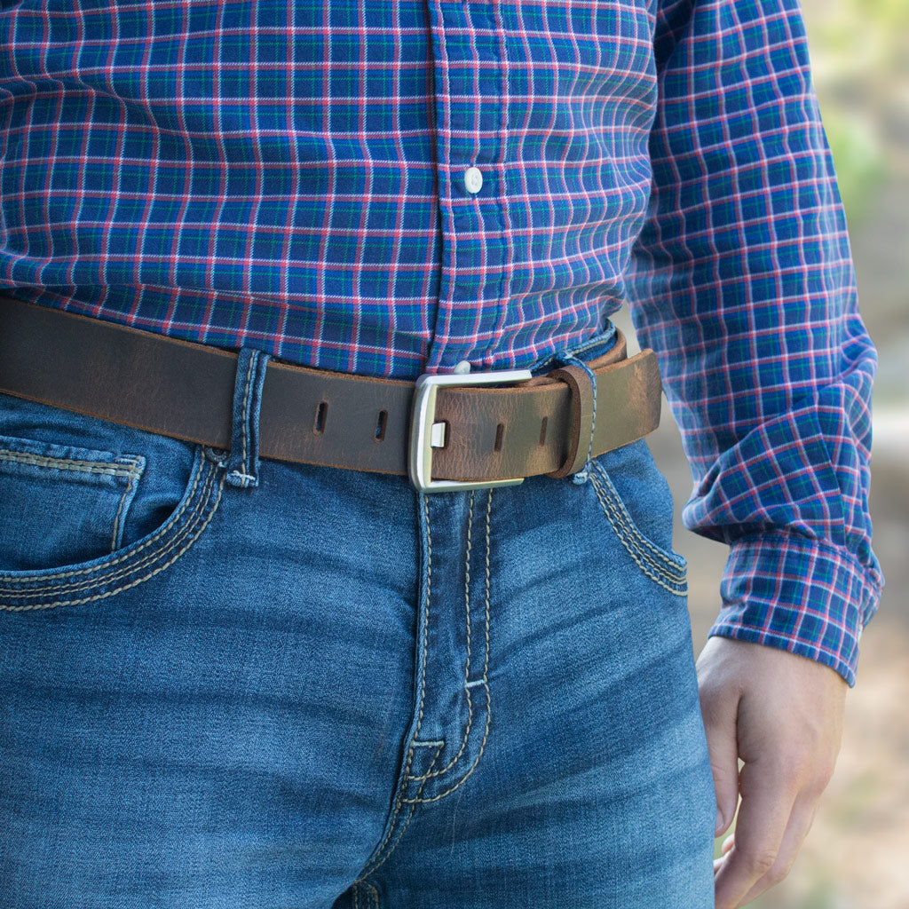Titanium Wide Pin Distressed Leather Belt on model in jeans. Distressed brown leather strap.
