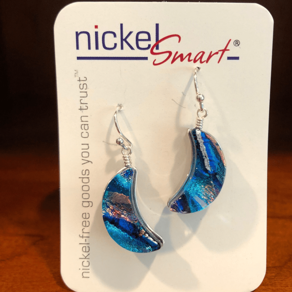 Blue Moon Dichroic Glass Earrings on an earring card. Beautiful crescent shape, predominantly blue.