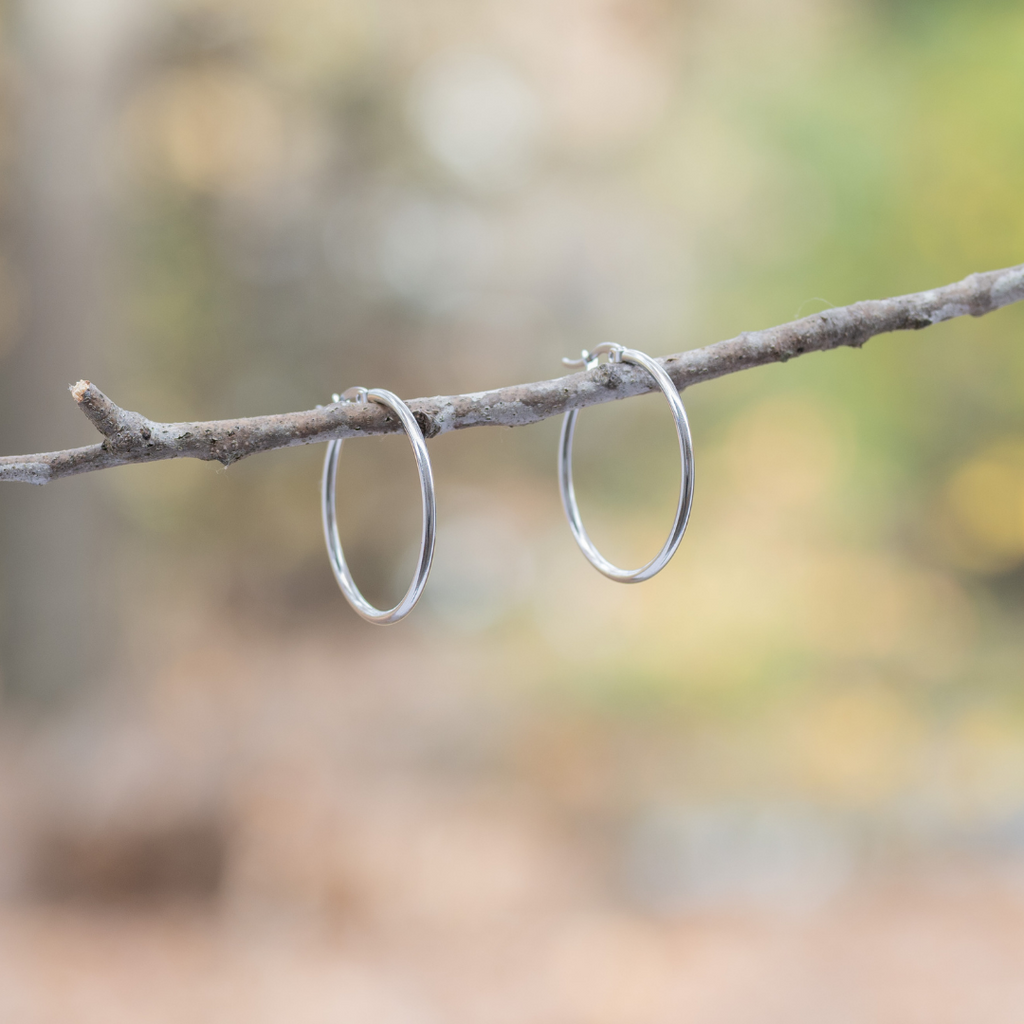 Stainless Steel Hoop Earrings - Silver by Nickel Smart. Medium-size hoop earrings in outdoor setting