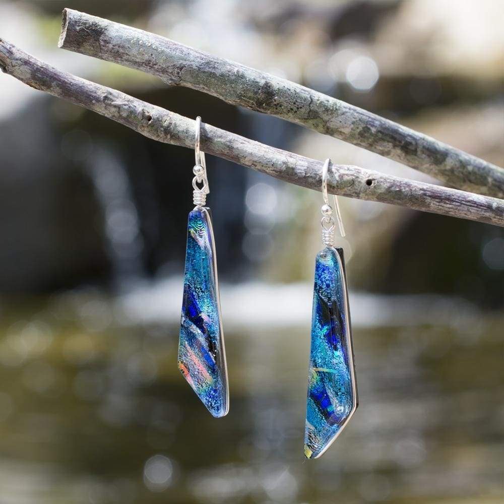 Cascades Earrings - Rainbow Blue. Outdoor setting. Brilliant shades of blue with rainbow accents.
