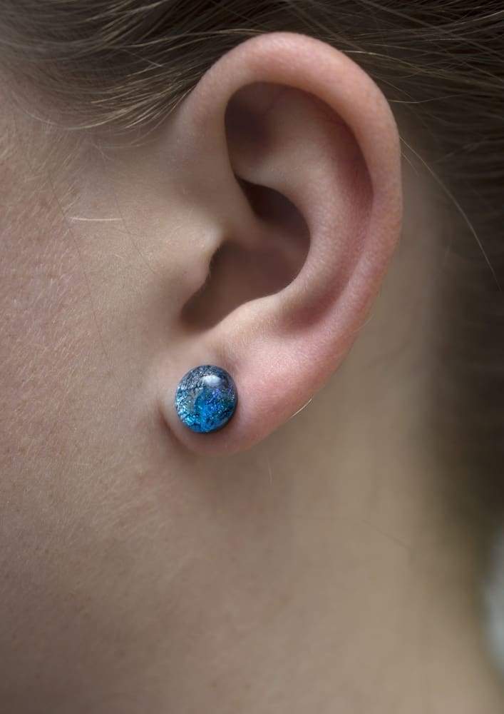 Cosmic Earrings on model. Hypoallergenic nickel-free earrings; small studs in shades of blue.