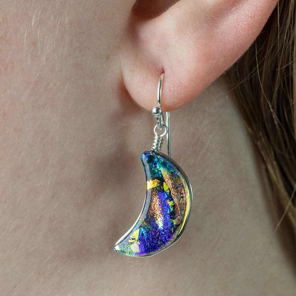 Close up picture of model in Moon Goddess Dichroic Glass Earrings; they dangle approximately 1.5".