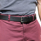 Slick City Black Leather Belt on model in salmon colored pants. Great casual belt; 1⅜" (35 mm) wide.