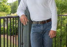 Outback Brown Leather Belt on model. Great for wear with jeans. Dark brown strap; silvery buckle.