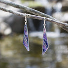 Queen Falls Earrings. Outdoor setting. Colors shine in the sun; mostly purple with other accents.